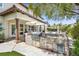 Outdoor kitchen with a built-in grill, stone accents, and stainless steel appliances overlooks the pool and landscaped yard at 628 Chervil Valley Dr, Las Vegas, NV 89138