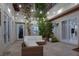 Charming courtyard with seating area, mature trees, and ambient lighting, perfect for outdoor entertaining at 628 Chervil Valley Dr, Las Vegas, NV 89138