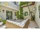 Cozy patio area with an outdoor wicker sectional, trees, and ambient string lights for relaxing evenings at 628 Chervil Valley Dr, Las Vegas, NV 89138