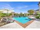 Stunning backyard oasis with sparkling swimming pool, waterfall features, and comfortable lounge area at 628 Chervil Valley Dr, Las Vegas, NV 89138