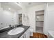 Clean bathroom features a single sink, shower-tub combo, neutral tones, and access to a walk-in closet at 6729 Churnet Valley Ave, Las Vegas, NV 89139