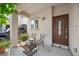 Inviting front porch with outdoor seating, plants, and a stylish front door at 6729 Churnet Valley Ave, Las Vegas, NV 89139