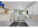 Modern kitchen with white cabinets, stainless steel appliances, and marble countertops at 6729 Churnet Valley Ave, Las Vegas, NV 89139