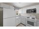 Well-lit kitchen showcasing white appliances, marble countertops, and ample cabinet space at 6729 Churnet Valley Ave, Las Vegas, NV 89139