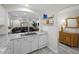 Bright kitchen area featuring white cabinetry, marble countertops, and an open view to the living area at 6729 Churnet Valley Ave, Las Vegas, NV 89139