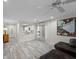 Open-concept living area with hardwood floors, a modern ceiling fan, and contemporary decor at 6729 Churnet Valley Ave, Las Vegas, NV 89139
