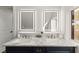 Bathroom featuring dual sinks, marble countertop, and decorative mirrors at 6920 Bradley Rd, Las Vegas, NV 89131