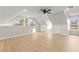 Spacious bonus room with light wood floors, ceiling fan, and dormer style windows at 6920 Bradley Rd, Las Vegas, NV 89131