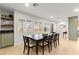 Spacious dining room with a long table, natural light, and open shelving at 6920 Bradley Rd, Las Vegas, NV 89131