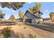 Stunning two-story home showcasing a gray exterior, attached garage, a circular driveway and mature landscaping at 6920 Bradley Rd, Las Vegas, NV 89131