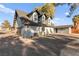 Charming gray two-story home with attached garage, mature trees, and a well-maintained circular driveway at 6920 Bradley Rd, Las Vegas, NV 89131