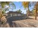 Beautiful gray home with a circular driveway and mature shade trees at 6920 Bradley Rd, Las Vegas, NV 89131