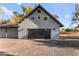 Attached garage with a black door and gray wood paneling at 6920 Bradley Rd, Las Vegas, NV 89131