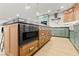 Kitchen island with built-in microwave, ample storage, granite countertops, and stylish light fixtures at 6920 Bradley Rd, Las Vegas, NV 89131
