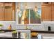 Bright kitchen features modern pendant lighting, granite countertops, and a farmhouse sink at 6920 Bradley Rd, Las Vegas, NV 89131