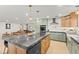 Modern kitchen featuring sage green cabinetry, granite countertops, and stainless steel appliances in an open layout at 6920 Bradley Rd, Las Vegas, NV 89131