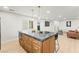 Bright kitchen island with granite countertops and gold accents, leading to an open-concept living space at 6920 Bradley Rd, Las Vegas, NV 89131