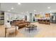 Open-concept living room and kitchen with large windows, bar seating, and comfortable furnishings at 6920 Bradley Rd, Las Vegas, NV 89131