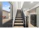 Staircase with black wood railing that leads to a laundry room at 6920 Bradley Rd, Las Vegas, NV 89131