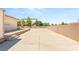 Spacious backyard showcasing a concrete expanse, framed by a sturdy block wall, offering privacy and potential at 7110 La Cienega St, Las Vegas, NV 89119