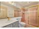Bathroom features a modern sink and vanity, with a tiled shower featuring gold trim at 7110 La Cienega St, Las Vegas, NV 89119