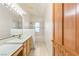 Bathroom featuring a marble countertop, wooden cabinetry, and a shower-tub combo with tiled walls at 7110 La Cienega St, Las Vegas, NV 89119