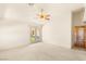 A spacious carpeted bedroom offers a ceiling fan and glass patio doors to outside at 7110 La Cienega St, Las Vegas, NV 89119