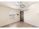 Well-lit bedroom showcasing a sliding barn door, modern ceiling fan, and stylish wood flooring at 7110 La Cienega St, Las Vegas, NV 89119