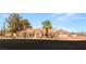 Charming single-story home showcasing desert landscaping, a terracotta roof, and a three-car garage at 7110 La Cienega St, Las Vegas, NV 89119