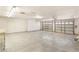 Expansive three-car garage with ample lighting, epoxy floors, built-in storage cabinets and multiple overhead doors at 7110 La Cienega St, Las Vegas, NV 89119