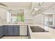 Bright kitchen featuring stainless appliances, white cabinets, and a large window overlooking the yard at 7110 La Cienega St, Las Vegas, NV 89119