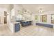 Spacious open-concept kitchen area with large windows, tile floors, and modern blue cabinets at 7110 La Cienega St, Las Vegas, NV 89119