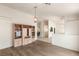 Open-concept living room featuring wood flooring, built-in shelving, and an arched entrance at 7110 La Cienega St, Las Vegas, NV 89119