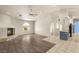 A spacious living area with a fireplace, views of the kitchen, and modern light-colored laminate flooring at 7110 La Cienega St, Las Vegas, NV 89119