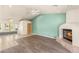 Bright open-concept living room with a fireplace, window seating, and access to a bedroom at 7110 La Cienega St, Las Vegas, NV 89119