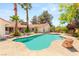 Backyard pool featuring cool blue water, mature palm trees, and an inviting spa area, perfect for outdoor enjoyment at 7110 La Cienega St, Las Vegas, NV 89119