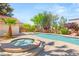 Resort-style pool and spa surrounded by lush landscaping, perfect for relaxation and outdoor enjoyment at 7110 La Cienega St, Las Vegas, NV 89119