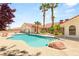 Inviting backyard pool and spa surrounded by lush landscaping and palm trees, perfect for relaxing and entertaining at 7110 La Cienega St, Las Vegas, NV 89119