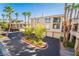 Well-maintained building exterior featuring balconies, attached garages, and landscaped grounds at 7159 S Durango Dr # 206, Las Vegas, NV 89113