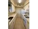 Well-equipped kitchen featuring appliances, ample counter space, and white cabinets at 7159 S Durango Dr # 206, Las Vegas, NV 89113