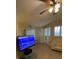 A living room features a ceiling fan, white couch and windows for plenty of natural light at 7159 S Durango Dr # 206, Las Vegas, NV 89113
