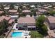 Aerial view of a two-story home featuring a pool, spa, covered patio, and manicured lawn at 7310 Heggie Ave, Las Vegas, NV 89131