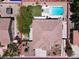 Aerial view of a backyard with a swimming pool, spa, patio, and lush landscaping at 7310 Heggie Ave, Las Vegas, NV 89131