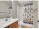 Bathroom with a single sink vanity and a shower/tub with a decorative curtain at 7310 Heggie Ave, Las Vegas, NV 89131