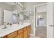 Bathroom with a double sink vanity and mirrors, offering ample space at 7310 Heggie Ave, Las Vegas, NV 89131