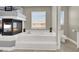 Bathroom featuring a soaking tub, fireplace, and modern fixtures at 7310 Heggie Ave, Las Vegas, NV 89131