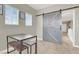 Bedroom with carpet, homework table, and a farmhouse-style sliding barn door at 7310 Heggie Ave, Las Vegas, NV 89131