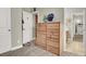 Bedroom featuring a wooden dresser, closet, and access to a bathroom at 7310 Heggie Ave, Las Vegas, NV 89131