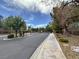 Entrance to a gated community with well-maintained landscaping and paved roads at 7310 Heggie Ave, Las Vegas, NV 89131