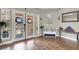 Welcoming entryway with decorative glass doors, wood floors, bench with storage, and interior decor at 7310 Heggie Ave, Las Vegas, NV 89131